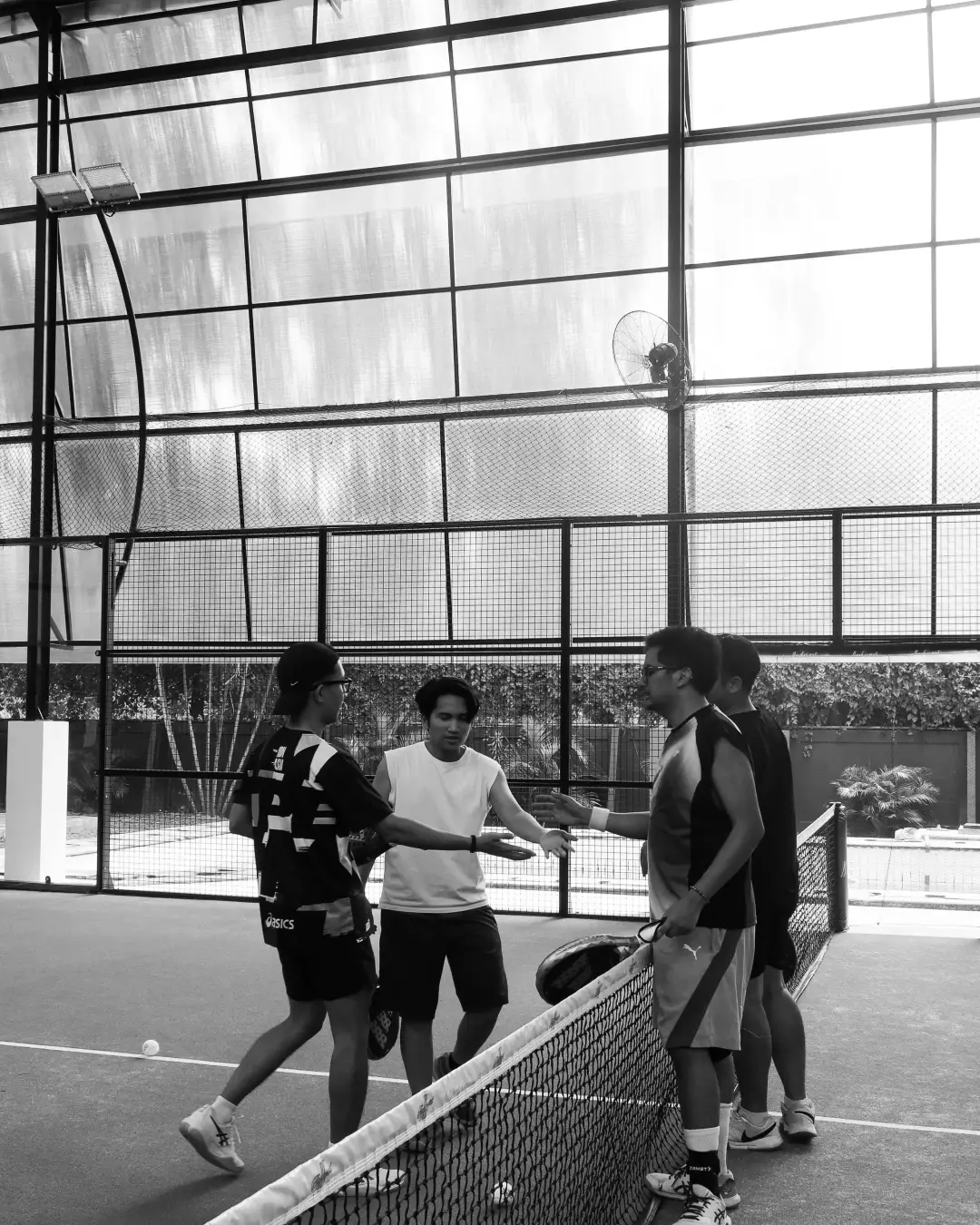 Black-and-white shot of players at the net