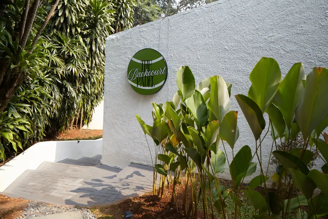 Garden wall with The Backcourt logo