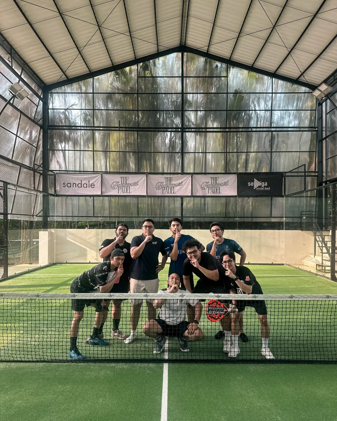 A group posing at the net